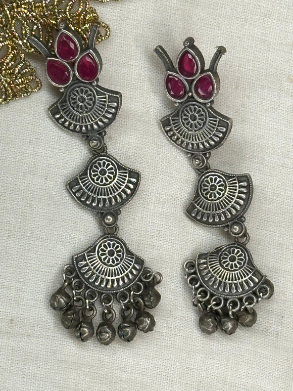 Stylish silver earrings featuring vibrant red stones